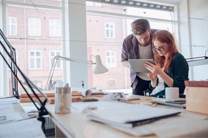 Man and woman looking at a tablet in an office