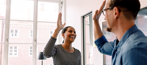 Woman and man high-fiving 