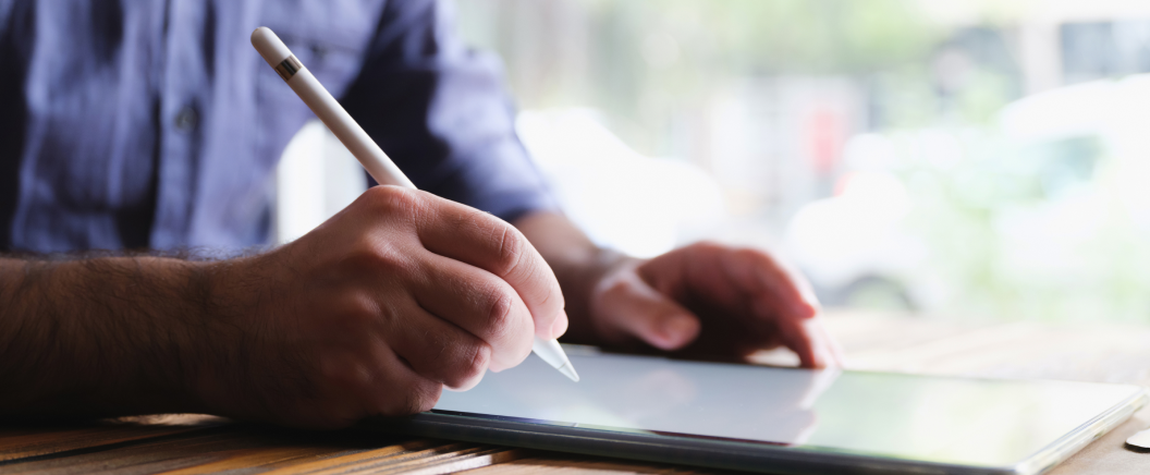 Man using stylus on tablet