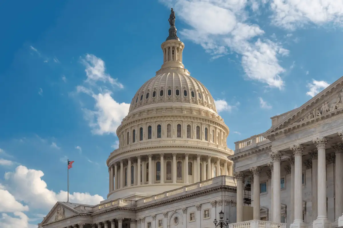 Capitol building with a blue sky with white clouds