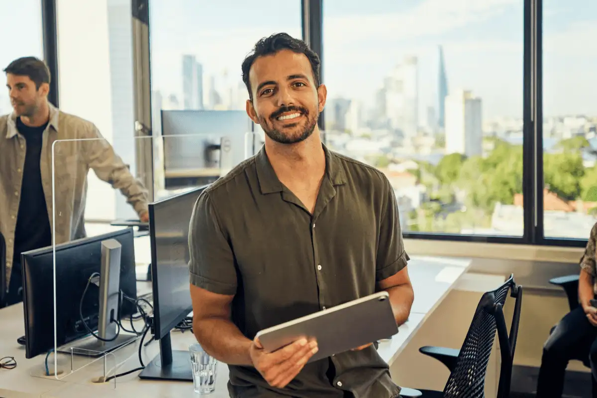 A man uses a tablet in an office