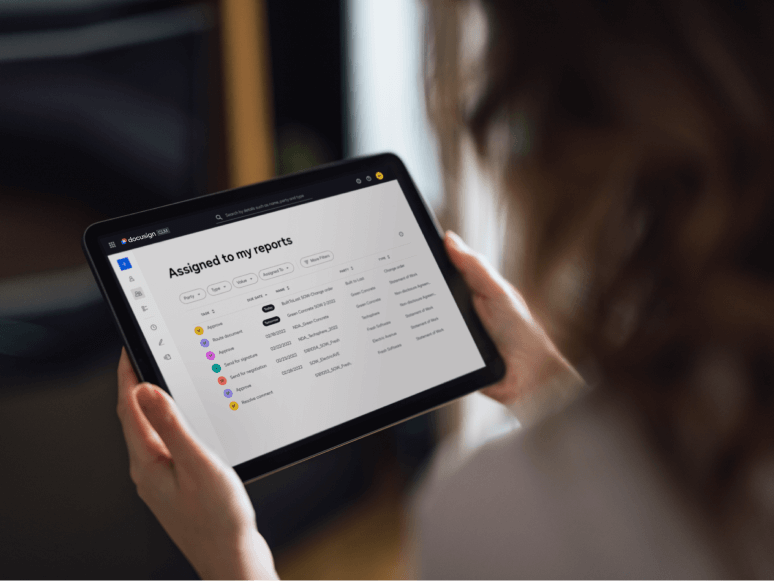 A tablet screen showing a dashboard in Docusign CLM of agreements assigned to the viewer's reports