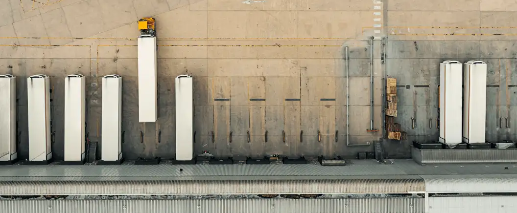 Trucks pull away from a warehouse