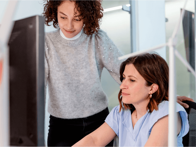 Two people collaborating on a computer